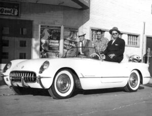 Port Theater Opening Day 1948. L to R: H.E. Brunson, L.R. Rigby and McMillan of McMillan Chevrolet, in Chevy Corvette.
